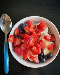High angle view of chopped fruits in bowl on table