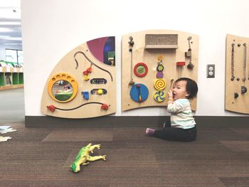 Full length of boy playing with toy car at home