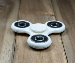 High angle view of blue fidget spinners on wooden table