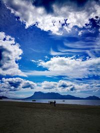 View of beach against cloudy sky