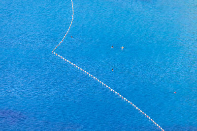 Lane buoys at the blue sea water . swimming people in vacation