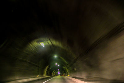 Road in illuminated tunnel