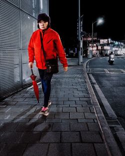 Full length of man running on street at night