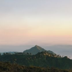 Scenic view of mountains against sky at sunset