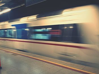 Blurred motion of train at railroad station