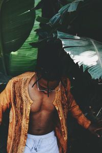 Close-up of shirtless man standing on floor