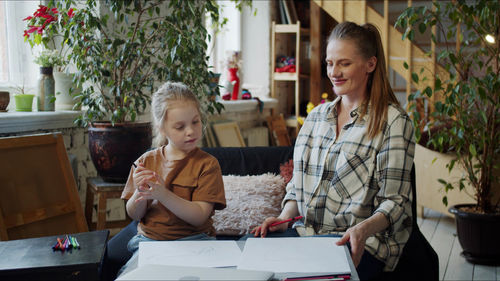 Portrait of smiling young woman working at home