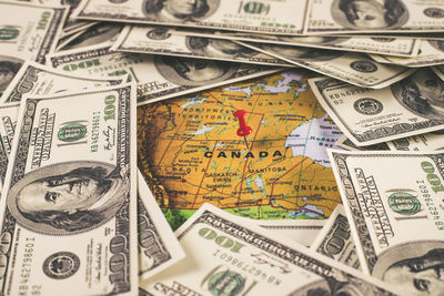 Close-up of american one hundred dollar bills with map