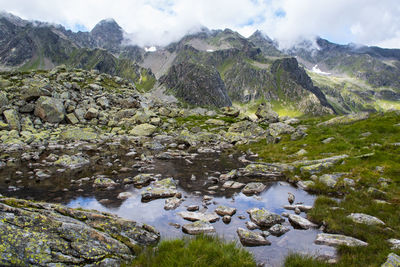 Scenic view of lake and mountains against sky