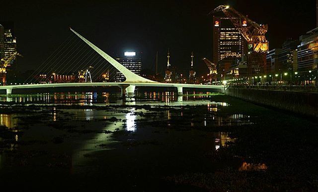 night, architecture, illuminated, built structure, reflection, building exterior, water, city, waterfront, bridge - man made structure, river, connection, building, street light, city life, outdoors, canal, modern, no people, bridge