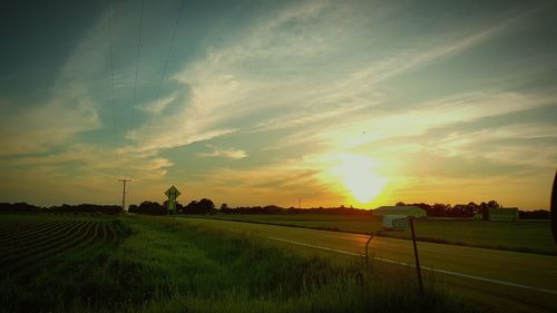 Scenic view of field against sky at sunset