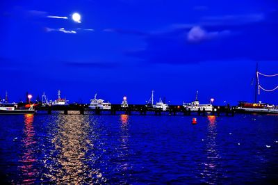 View of illuminated harbor at night