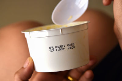 Close-up of person holding coffee cup