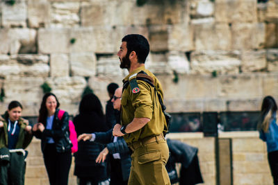 Full length of men standing against historic building