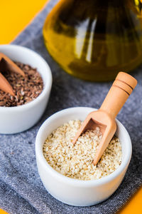 Sesame and flax seeds wooden spoons with oil in glass bottle. healthy food concept. vegan keto diet. 