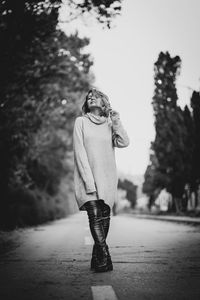 Full length of woman standing against plants