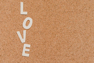 Directly above shot of love text on cardboard
