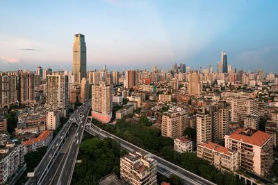 High angle view of street amidst buildings in city against sky