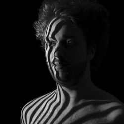 Young man looking away in darkroom