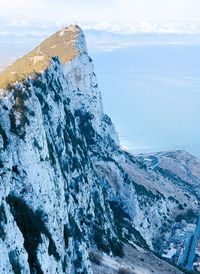 Scenic view of snowcapped mountains by sea against sky