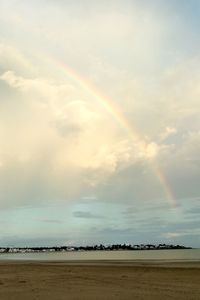 Scenic view of rainbow over sea against sky