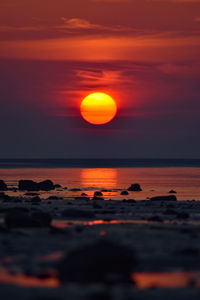 Scenic view of sea against romantic sky at sunset