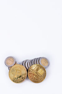 High angle view of coins on white background
