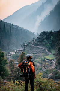 Rear view of man standing on mountain