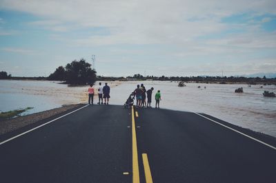People on flooded highway
