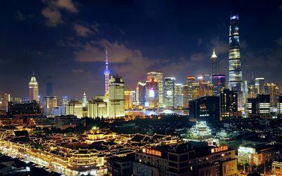 Illuminated cityscape against sky at night