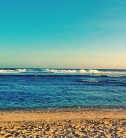 Scenic view of sea against clear blue sky