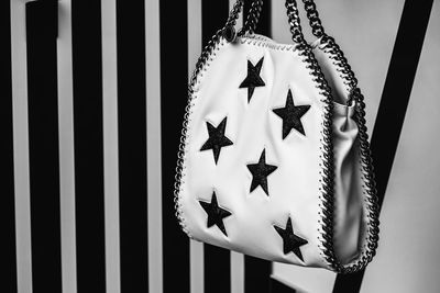 Close-up of purse with star shapes against wall