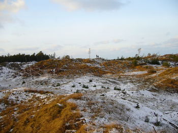 Scenic view of landscape against cloudy sky