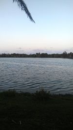 Scenic view of lake against clear sky at sunset