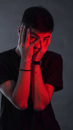Portrait of man wearing hat against black background