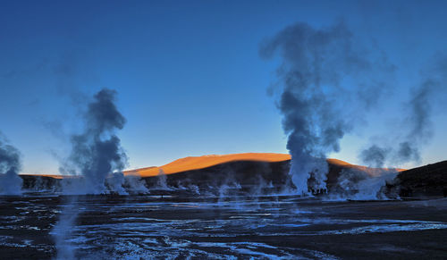 Panoramic view of volcanic landscape against sky at sunrise