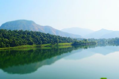 Scenic view of lake and mountains against clear sky