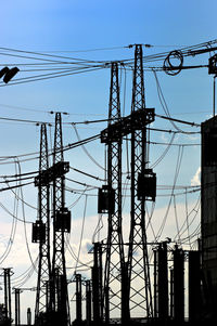 Low angle view of electricity pylon against sky