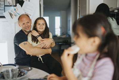 Loving father and daughter hugging at home