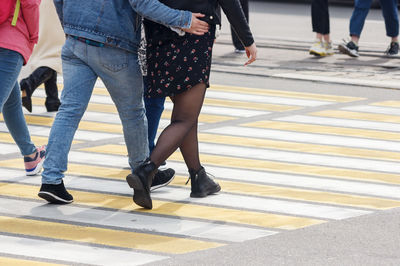 Low section of people walking on road