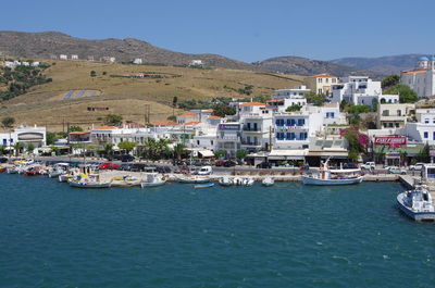 Scenic view of sea by town against sky