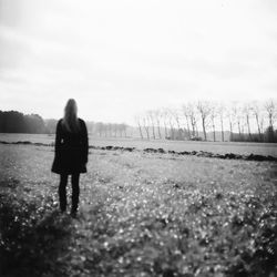 Rear view of a woman standing in water