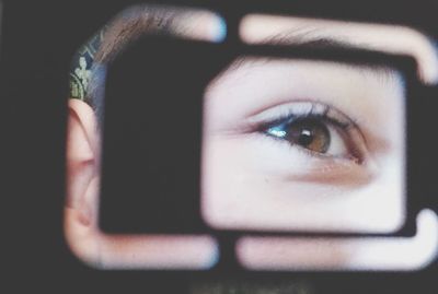 Close-up portrait of young woman with camera