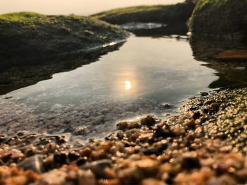 Close-up of water against sky at sunset