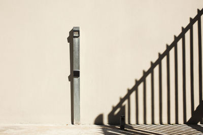 Close-up of metal fence against wall