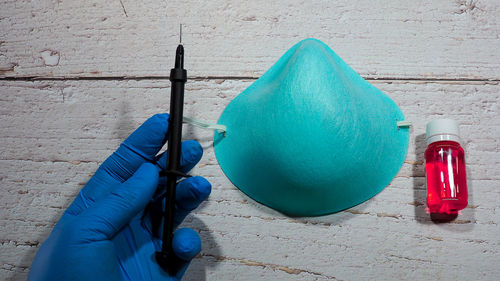 High angle view of person holding umbrella on table against wall