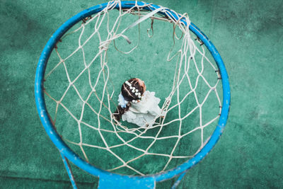 High angle view of girl and basketball hoop