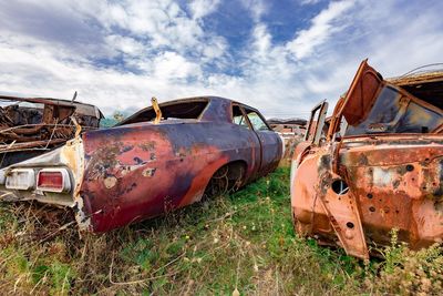 Abandoned truck on field against sky