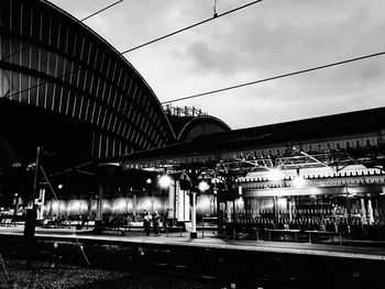 Illuminated railroad station platform against sky