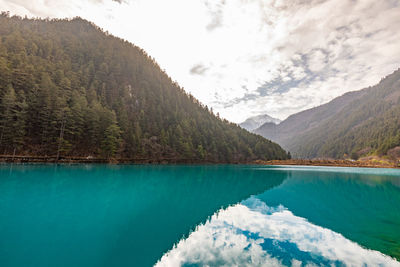 Scenic view of lake and mountains against sky